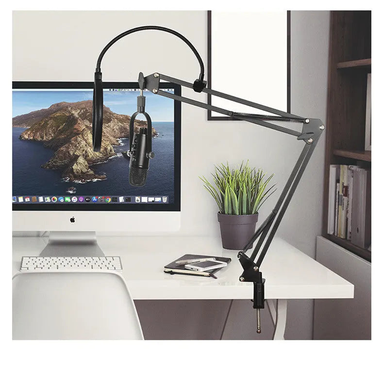 Black BM-86PRO USB condenser microphone with metal stand and sponge pop filter on a desk.