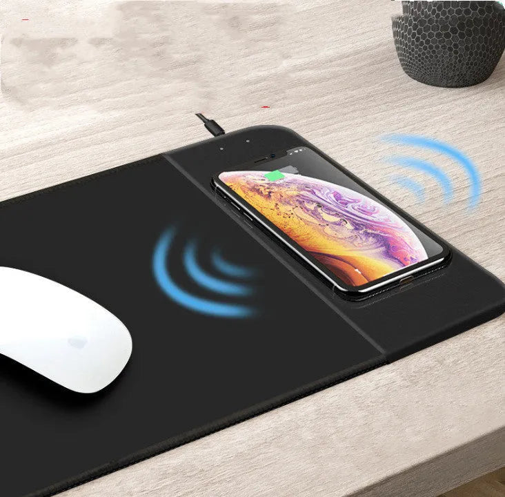 Wireless charging mouse pad with cartoon design and RGB lighting on desk