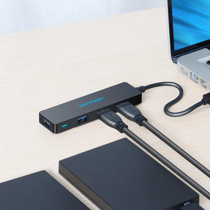 Black four-port USB 3.0 hub with a short cable and nickel-plated ports