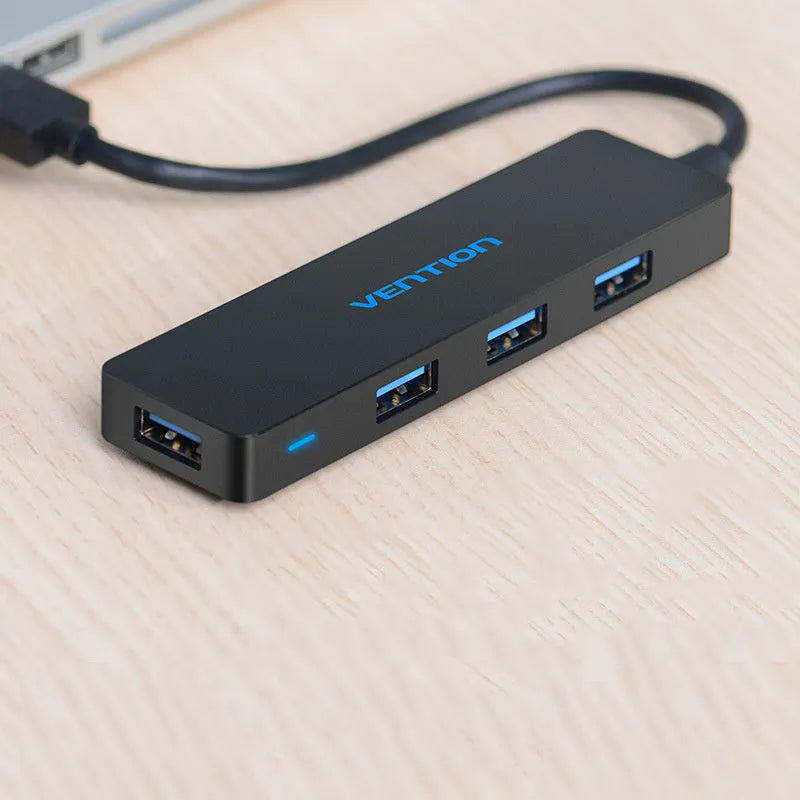 Black four-port USB 3.0 hub with a short cable and nickel-plated ports