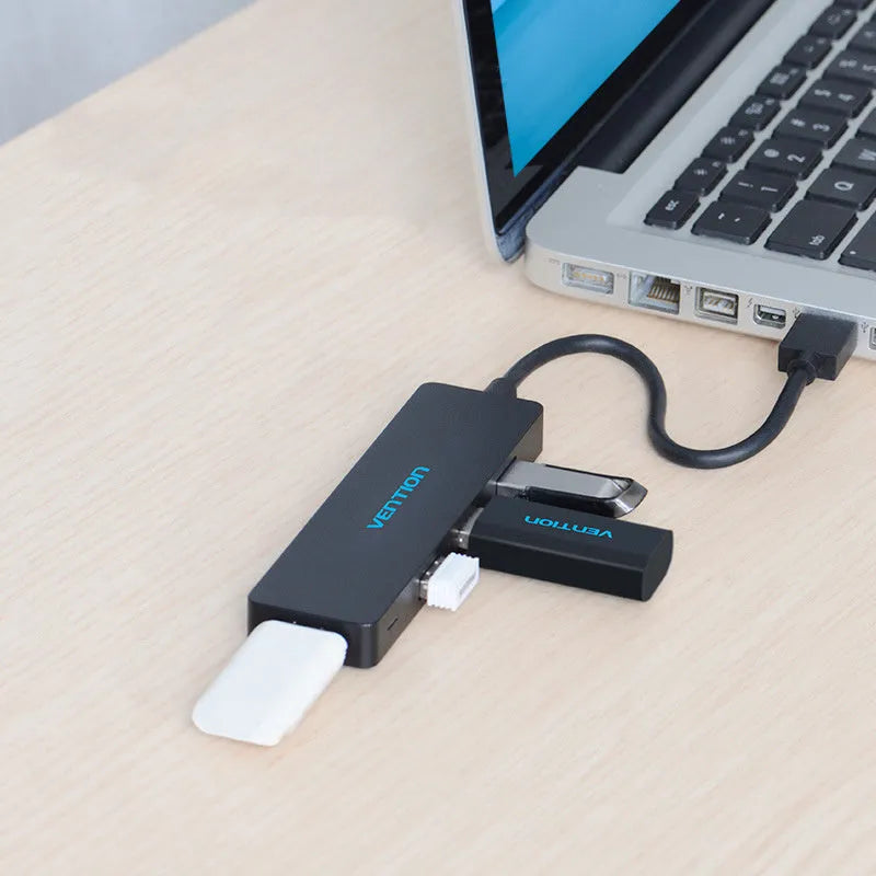 Black four-port USB 3.0 hub with a short cable and nickel-plated ports