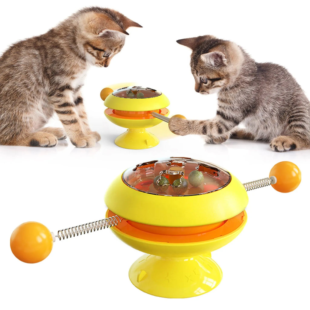 Rotating turntable cat toy with suction cup base and visible catnip balls in transparent top.