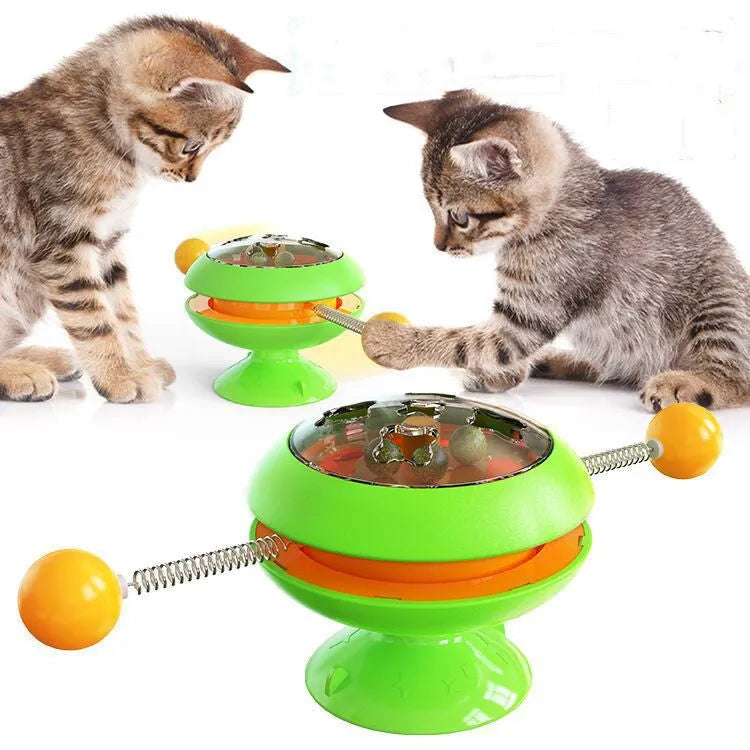 Rotating turntable cat toy with suction cup base and visible catnip balls in transparent top.