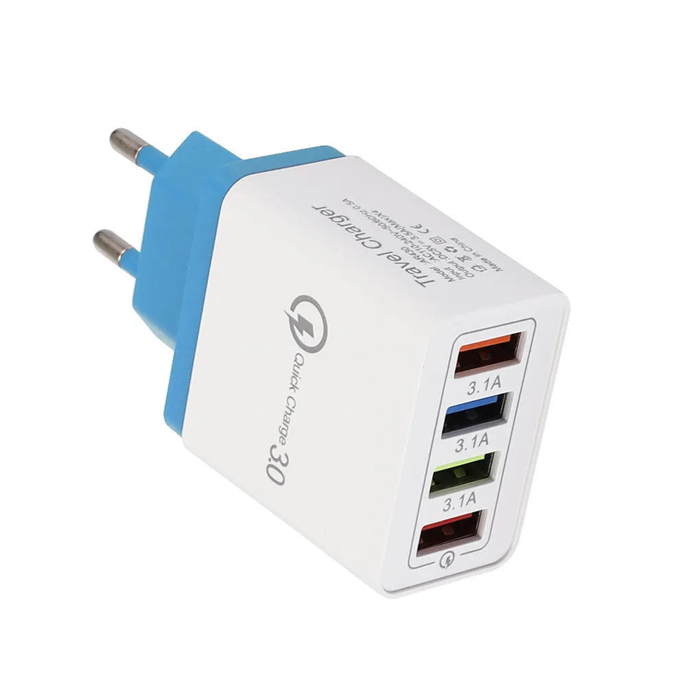 Compact 4-port USB mobile phone charger in multiple colours, shown plugged into a UK wall socket.