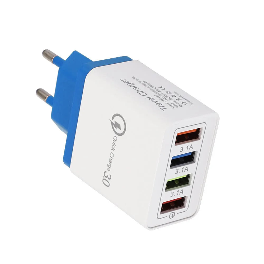 Compact 4-port USB mobile phone charger in multiple colours, shown plugged into a UK wall socket.