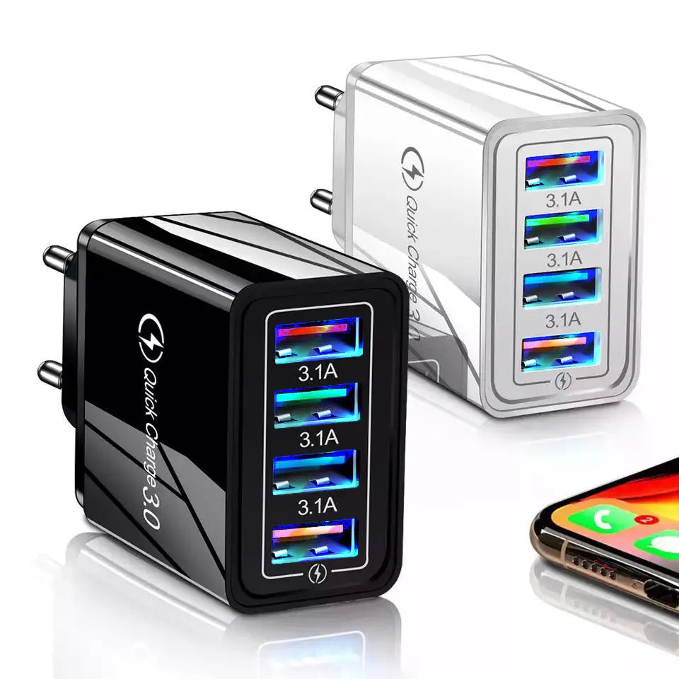 Compact 4-port USB mobile phone charger in multiple colours, shown plugged into a UK wall socket.