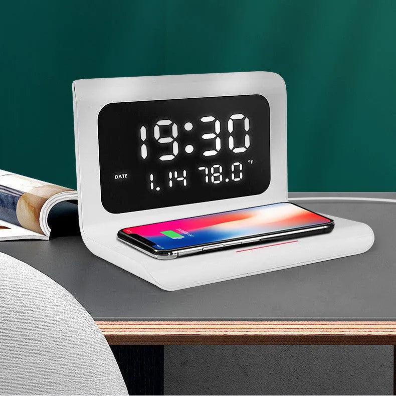 White wireless charger alarm clock showing digital display with time, date, temperature and humidity readings