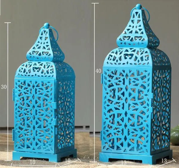 Blue iron candelabra lantern with geometric cut-out pattern measuring 14x14x38 cm
