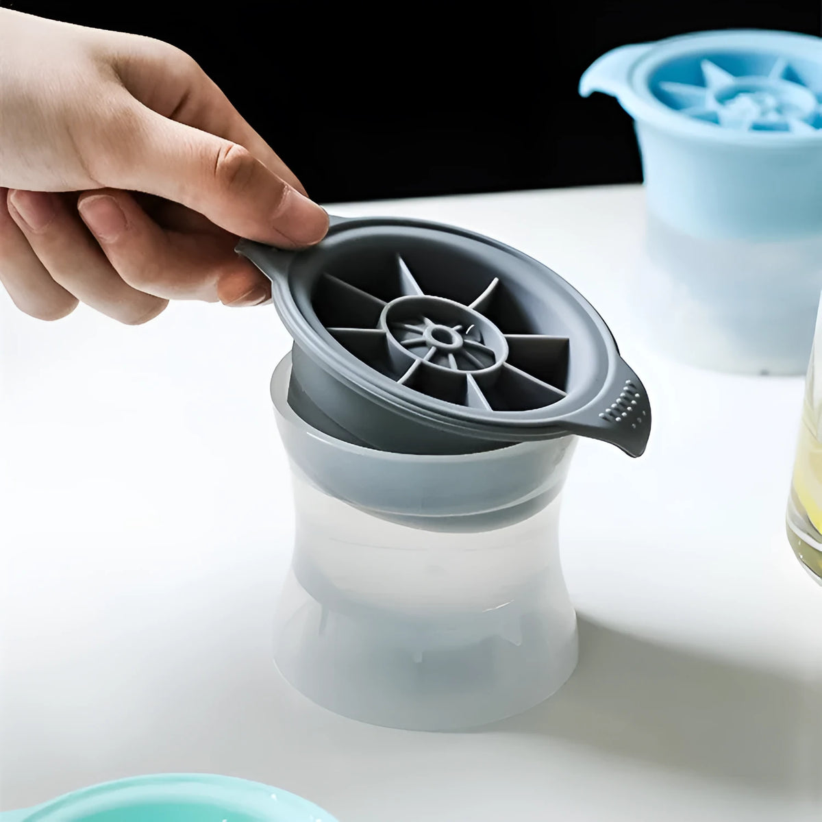 Silicone ice tray producing large hockey-shaped ice cubes in light grey colour