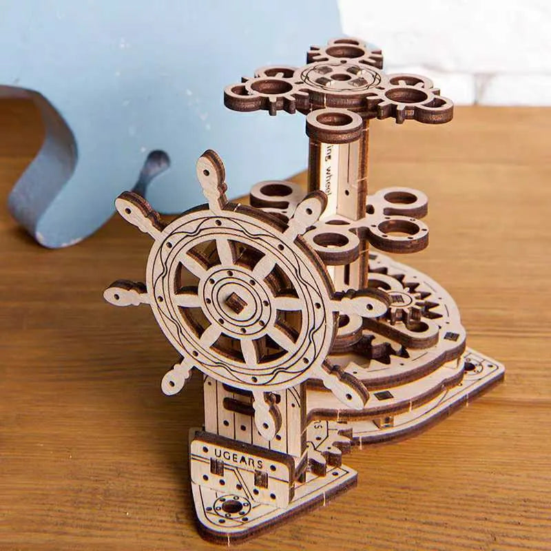 Wooden desk model with a rotating steering wheel holding pens and pencils.