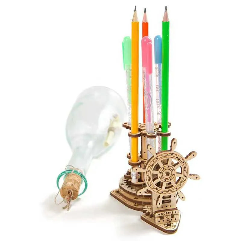 Wooden desk model with a rotating steering wheel holding pens and pencils.