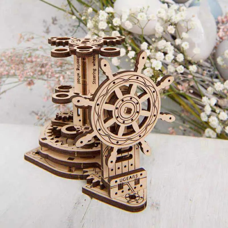 Wooden desk model with a rotating steering wheel holding pens and pencils.