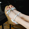Women's pink wedge sandals with thick heel, fish mouth toe, and buckle closure on a white background