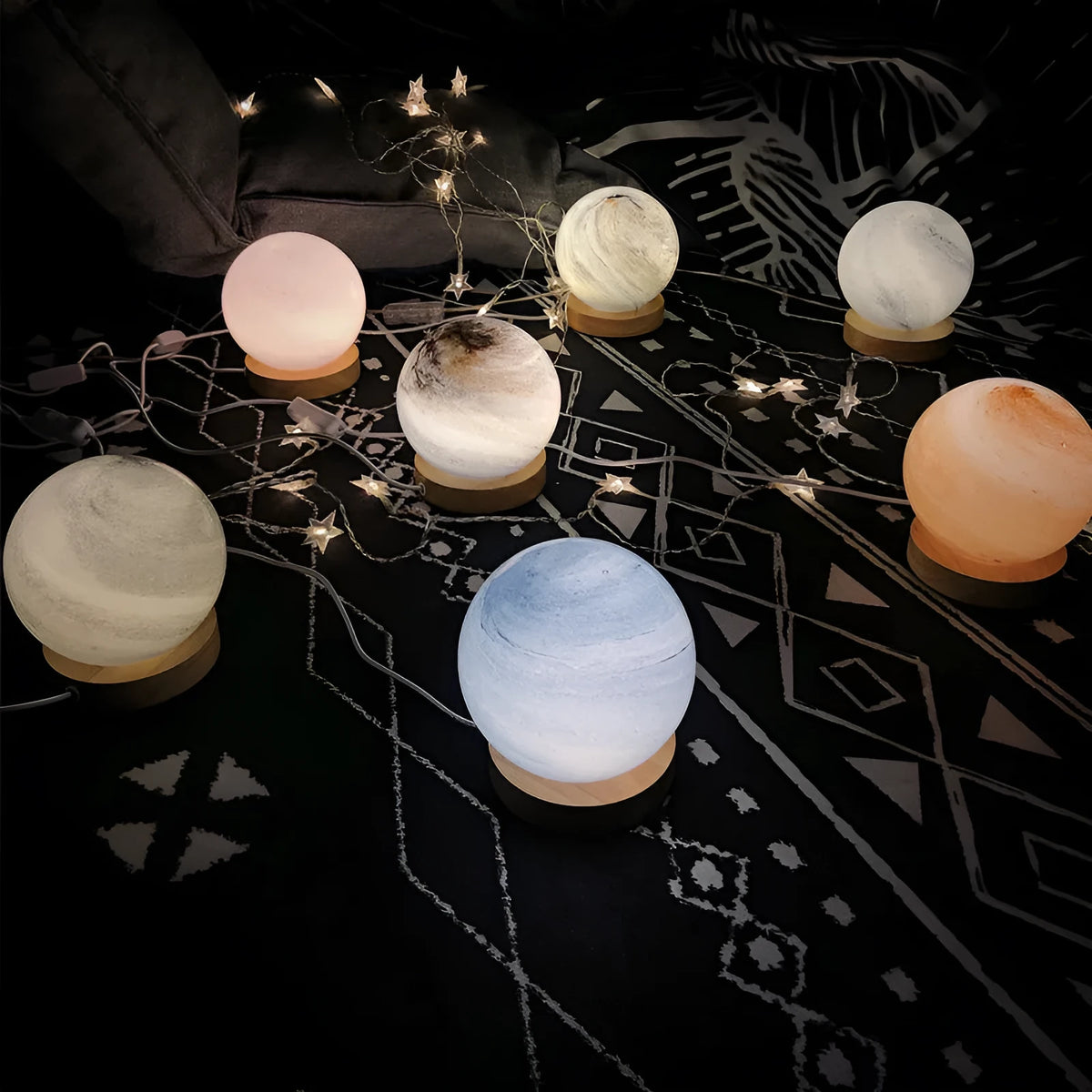 Nordic style USB table lamp with a glass shade in one of seven colour options on a bedside table.