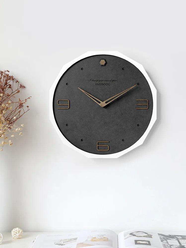 12 inch round Nordic minimalist wall clock in walnut ash finish on a light-coloured wall.