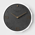 12 inch round Nordic minimalist wall clock in walnut ash finish on a light-coloured wall.