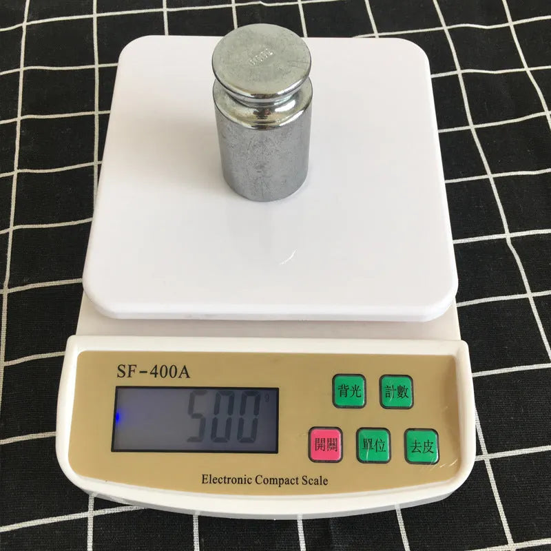 SF-400A black electronic kitchen scale with digital display on a kitchen worktop.