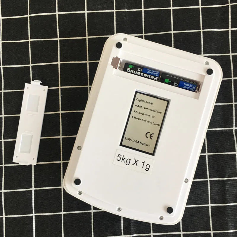 SF-400A black electronic kitchen scale with digital display on a kitchen worktop.