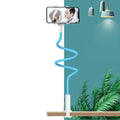Blue flexible gooseneck mobile phone holder mounted on a bedside table