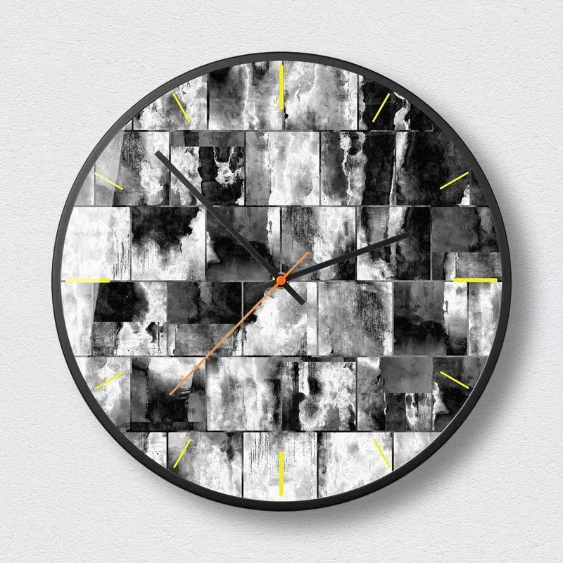 Round abstract art design wall clock with metal case on a wall.