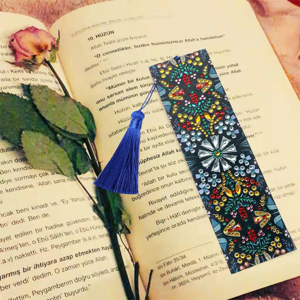 Close-up of a leather bookmark with a hand-embroidered mandala flower design in special-shaped diamond rhinestones.