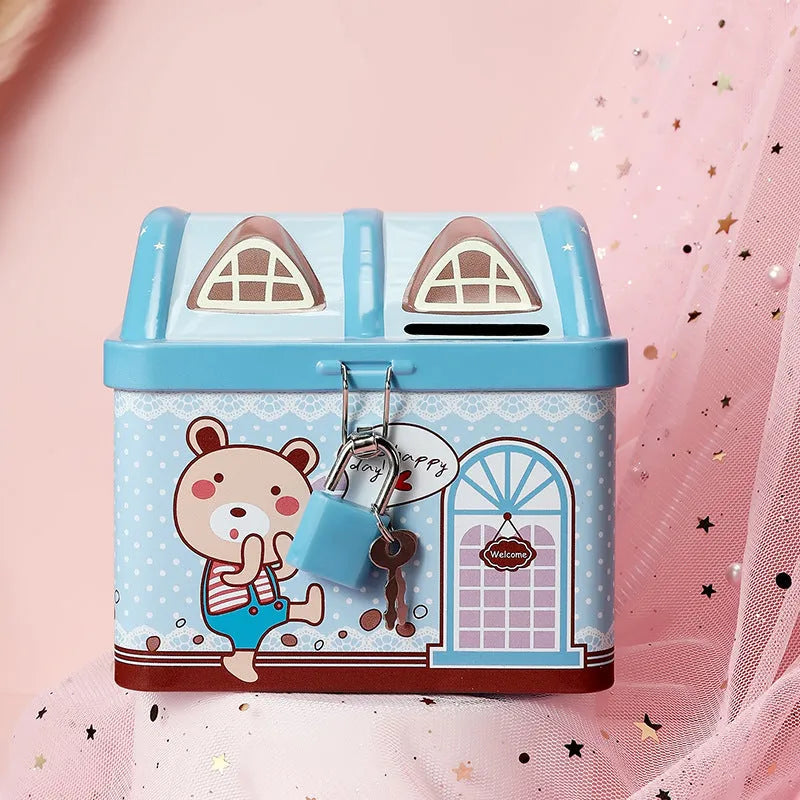 Blue or pink round house-shaped tinplate piggy bank with coin slot.