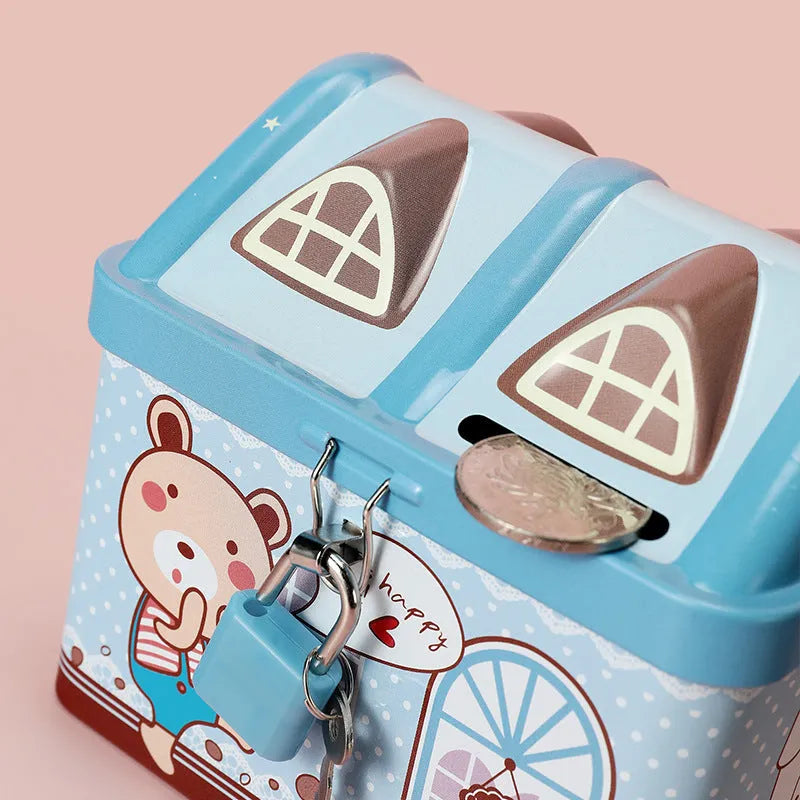 Blue or pink round house-shaped tinplate piggy bank with coin slot.