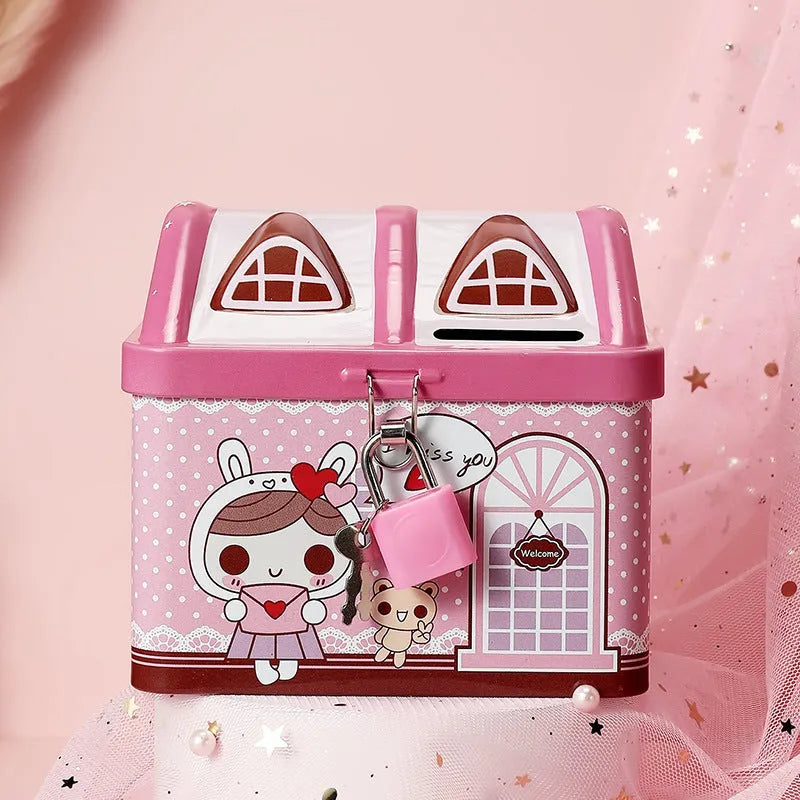 Blue or pink round house-shaped tinplate piggy bank with coin slot.