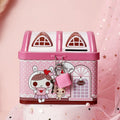 Blue or pink round house-shaped tinplate piggy bank with coin slot.