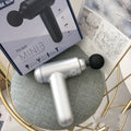 God Fascia Gun muscle massager in black, red or white with three attachment heads