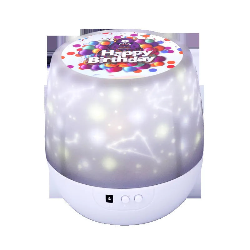 Compact white starry sky projector displaying blue constellation patterns on a dark wall.