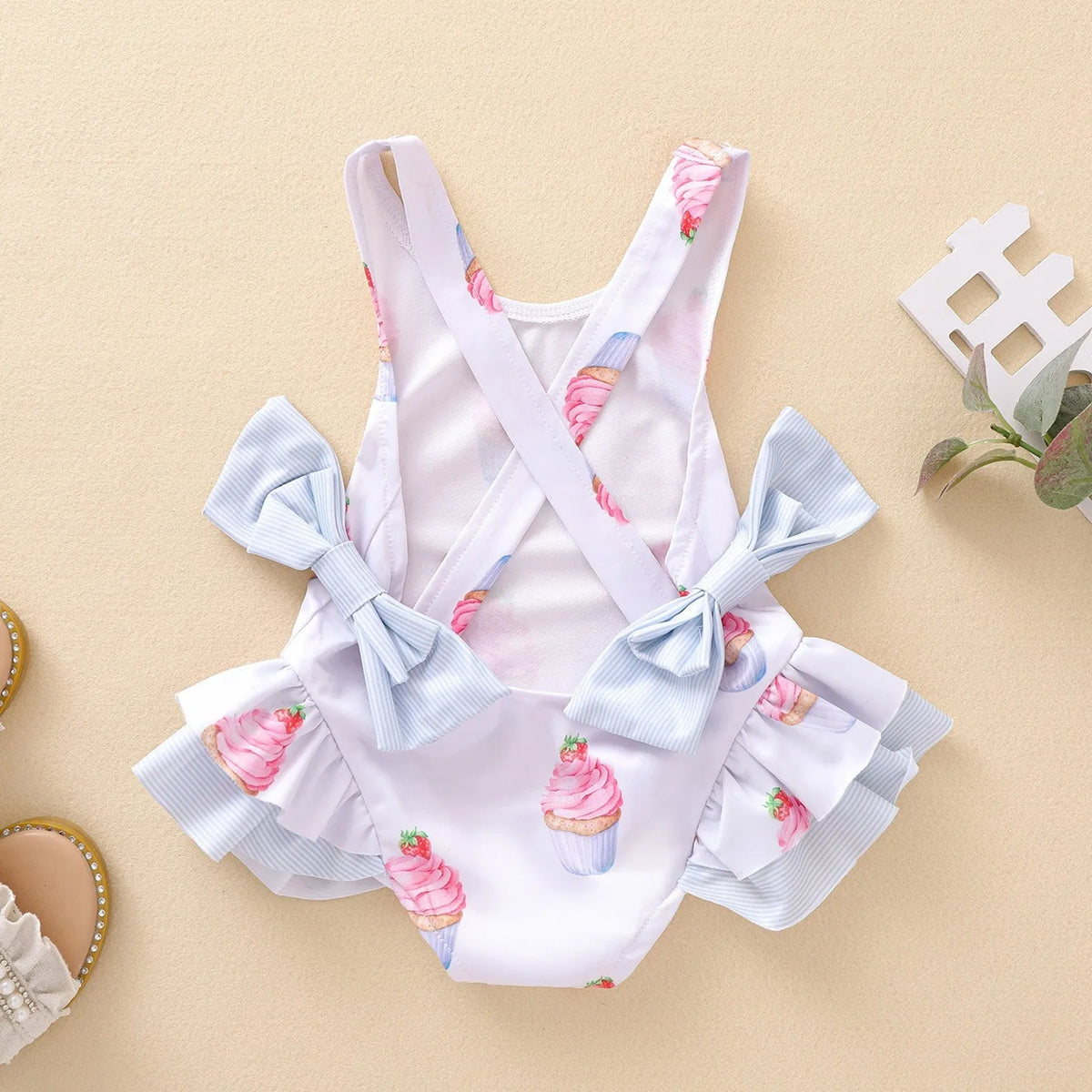 Girls white print sundress shown in sizes 80cm to 130cm, suitable for ages 3 months to 14 years