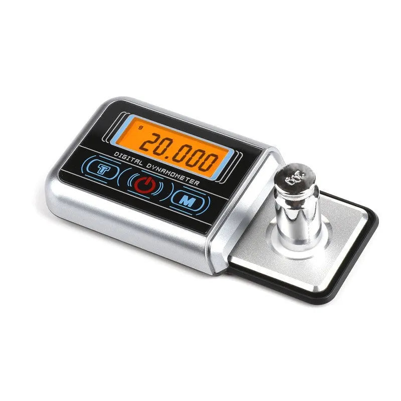 A precision electronic scale and turntable needle pressure gauge on a work surface.