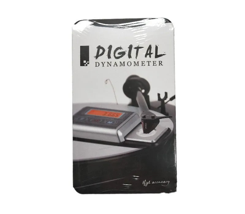 A precision electronic scale and turntable needle pressure gauge on a work surface.