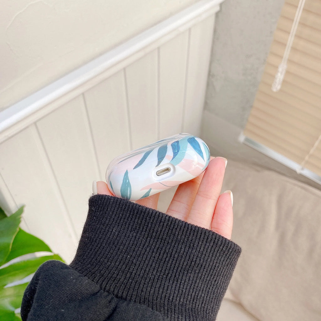 Blue and Green TPU earphone cases with tropical banana leaf design for Apple AirPods.
