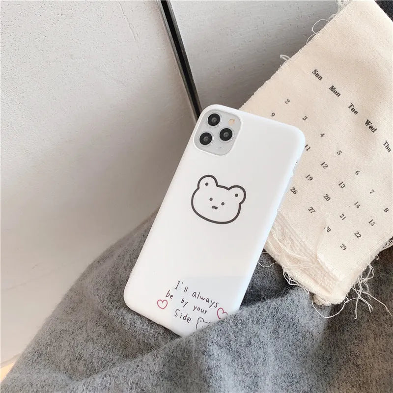 Soft silicone iPhone case featuring a cartoon Korean bear design on a white background.