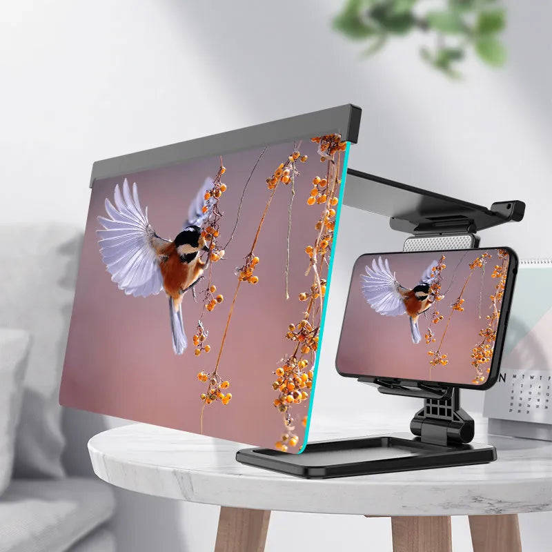 Black folding mobile phone screen amplifier with detachable holder, shown magnifying a smartphone display.