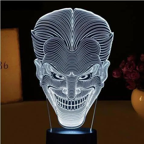 USB-powered 3D acrylic LED table lamp with remote control on a desk, displaying a gradient colour mode.