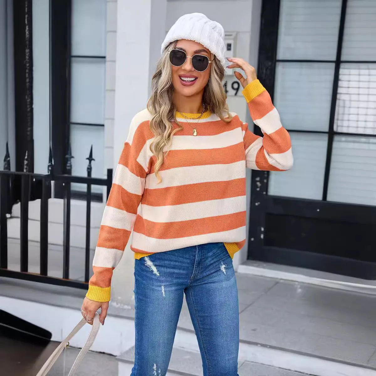 Blue loose-fit women's acrylic sweater with long sleeves and a striped pattern.