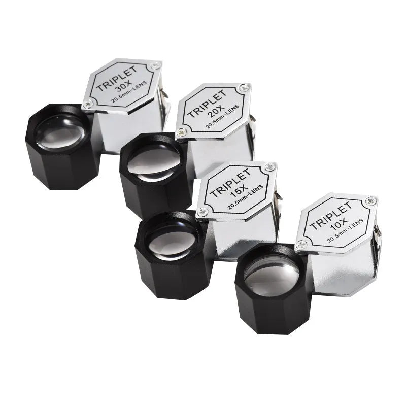 Handheld metal portable magnifying glass for jewellery and coin inspection with optical glass lenses.