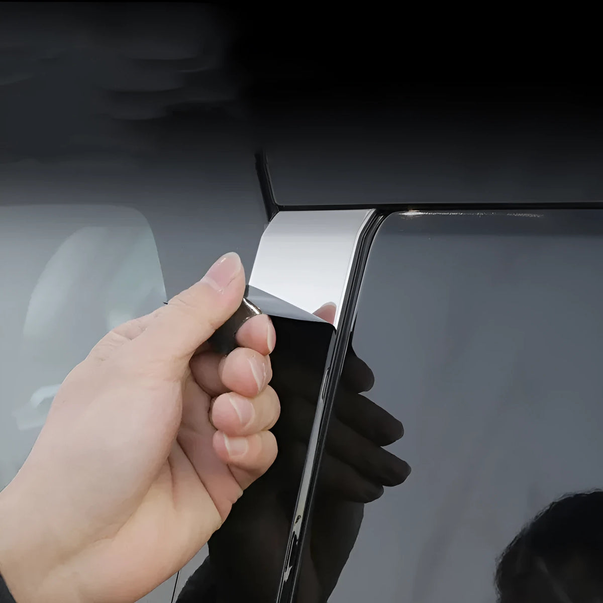 Packages of bright black and carbon fibre pattern adhesive films for Mitsubishi Outlander window pillars.