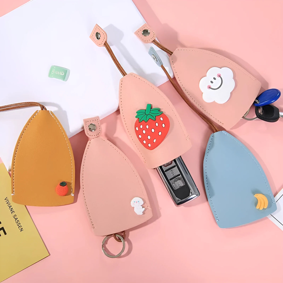 Cartoon-design PU leather pull-out key case for car keys, shown with pull tab extended.