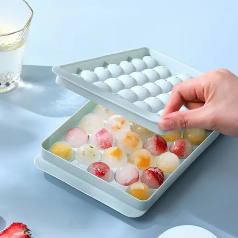 Blue silicone ice cube tray with 33 round grids and integrated lid showing 24x14x3cm dimensions