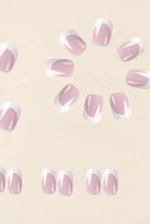 24 white plastic fake nails with a black and grey plaid pattern, arranged on a table.