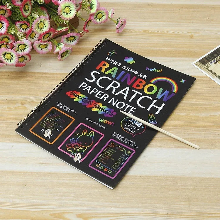 Large sheet of black scratch art paper for children, with a colourful revealed pattern showing through scraped areas.