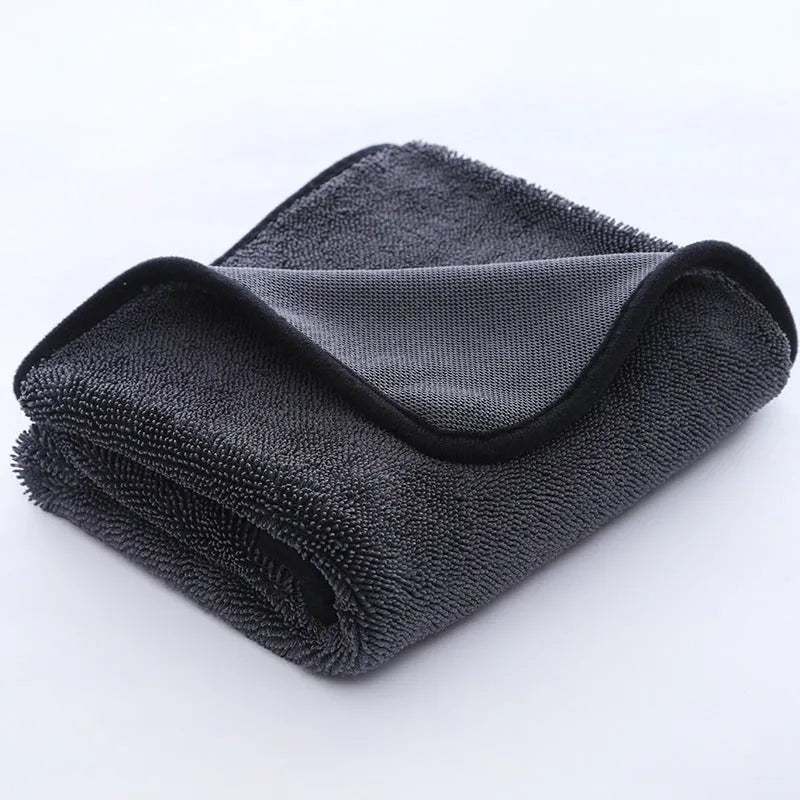 Grey car cleaning towel with black edge trim showing hemmed sides and spiral hair texture.