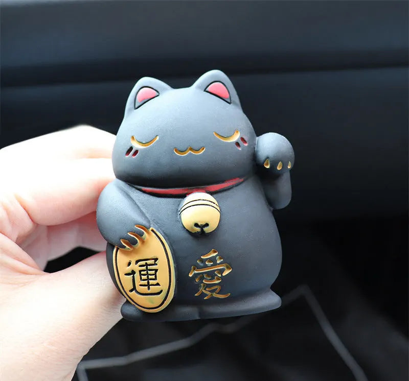Resin fortune cat car vent aromatherapy clip in black or white.