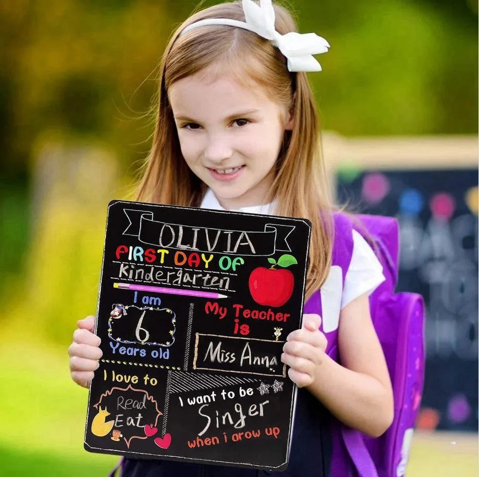 Wooden blackboard with first day of school design on density plate measuring 25.5 by 30 centimetres