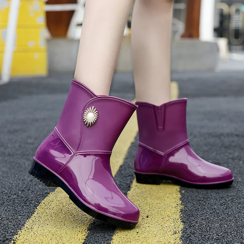 Women's purple PVC rain boot with non-slip sole and middle tube height.