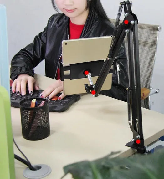 Adjustable black and white phone tablet stand on flat surface with mobile device